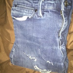 Worn blue jeans with little rips